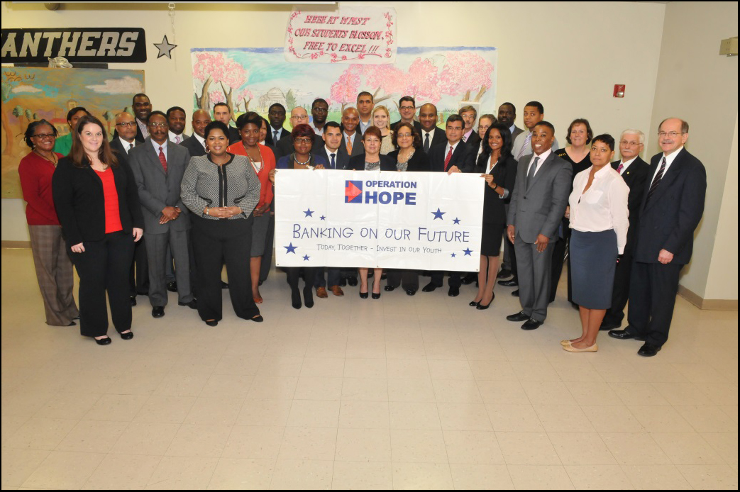 Operation HOPE gathers volunteers from various federal agencies to support teaching students financial literacy principles at the Banking On Our Future event.