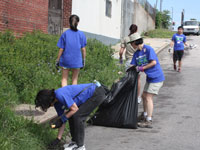 Volunteers help clear debris as part of the street-to-street cleanup of the Ivy City neighborhood.